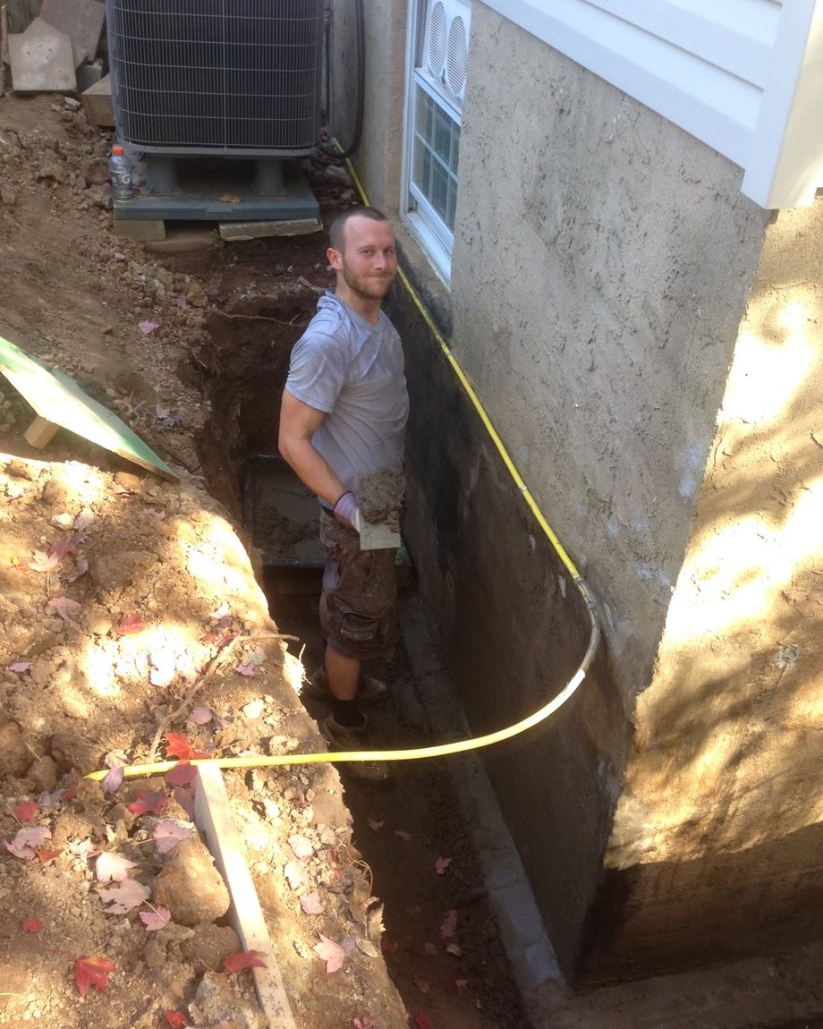 Inspector documenting a home's foundation and crawlspace
