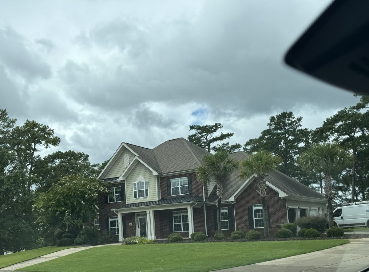 Inspector evaluating a single-family home exterior