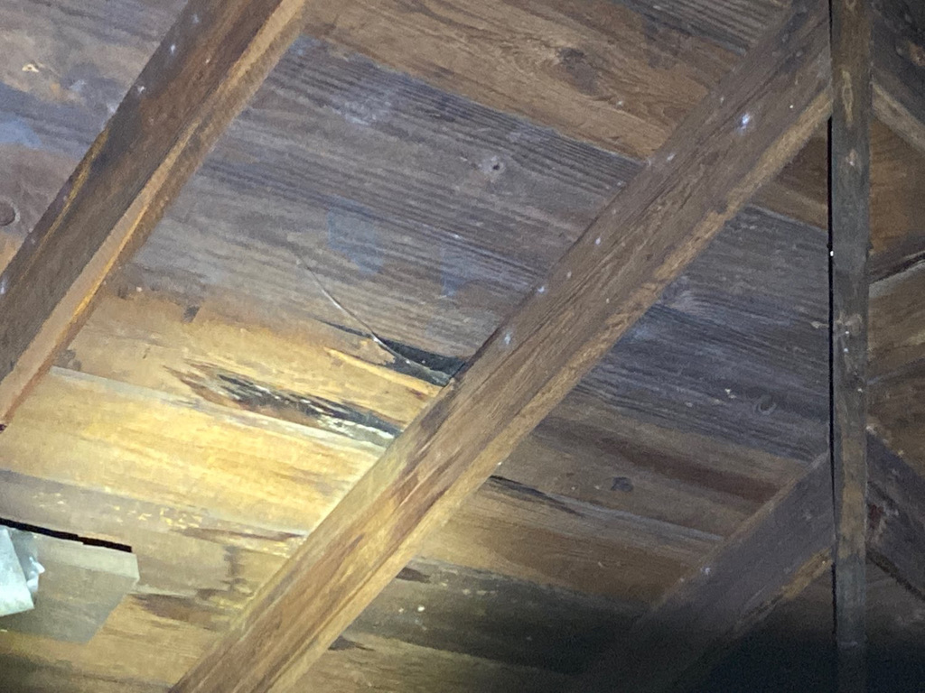 Previously documented roof condition being re-examined at a verification visit